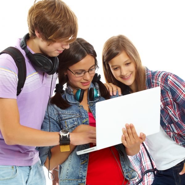 Three teenagers studying with laptop